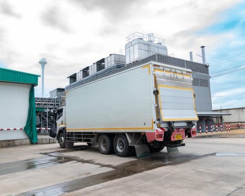 refrigerated-truck-is-waiting-be-loaded-inside-factory_330609-2100